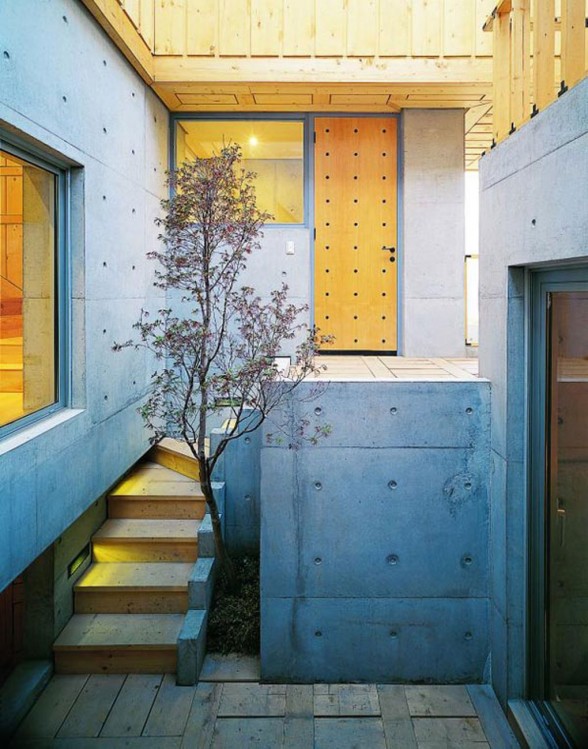 Great Combination of Wood and Concrete in a Courtyard House Design - Wooden Entrance Door