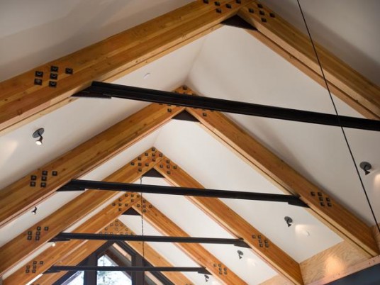 Glue Laminated Wood Beams Connected One Another with Steel Collar Ties Exposed for Raised A-frame Ceiling