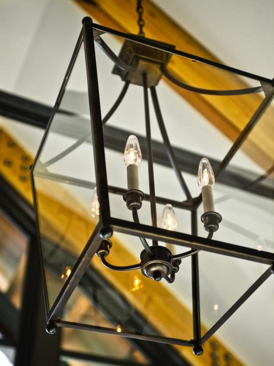 Classic Style Chandelier in Black Combined with Exposed Steel Collar Connecting Beams on Ceiling for Captivating Interior Decoration