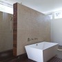 Contemporary Passive Solar House Design for Beneficial Residing: Simple White Bathtub In Prism Shape Design Combine With Wood And Tiles Divided From Shower Space